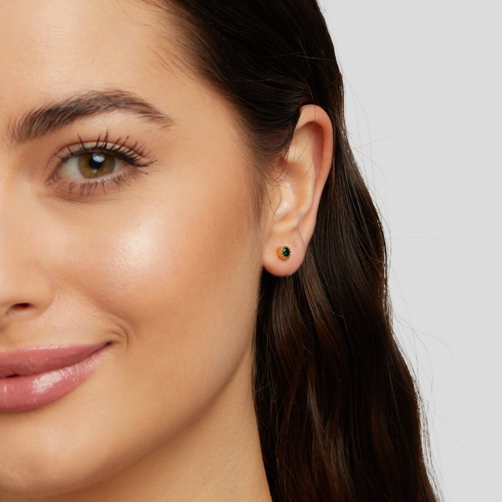 ヴィクトリア – 緑の石をあしらったゴールドのイヤリング。